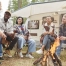 Friends talking around a campfire.