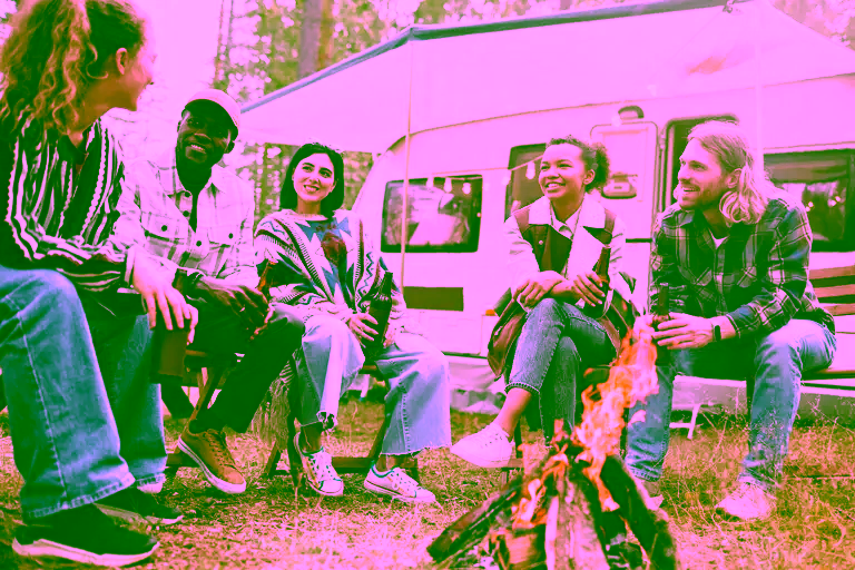 Friends talking around a campfire.